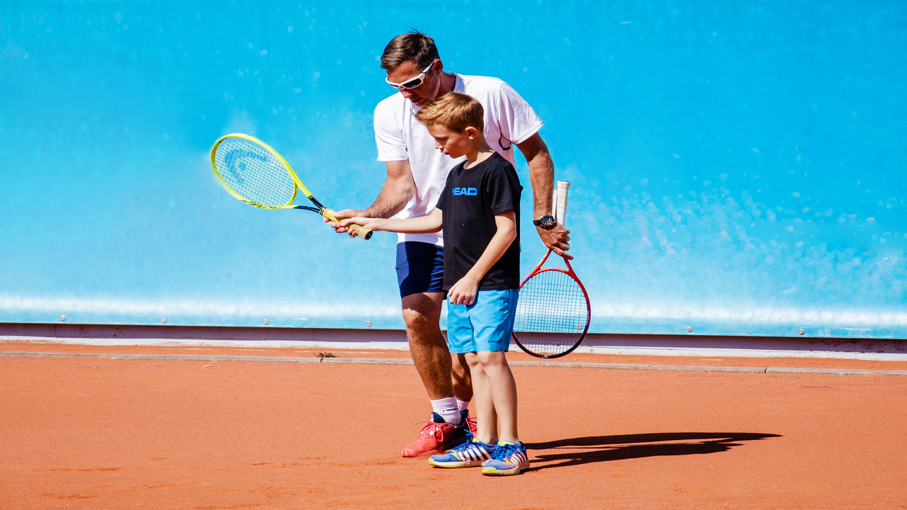 tennis coach and kid